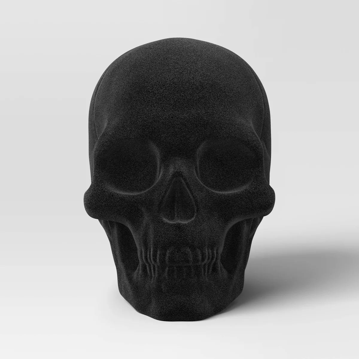 PLASTIC FLOCKING SKULL FIGURINE