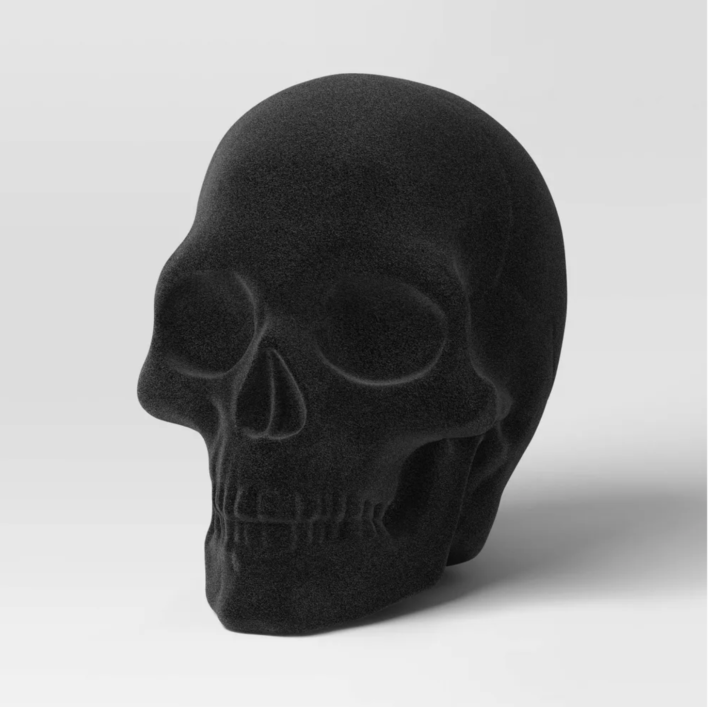 PLASTIC FLOCKING SKULL FIGURINE